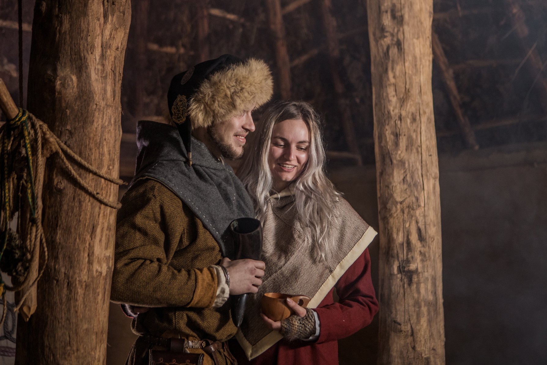 A viking couple in a viking settlement hall